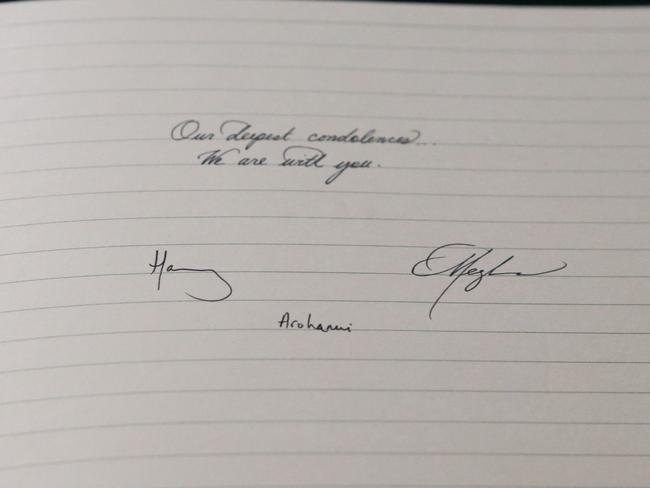 The message written and signed by the Duke and Duchess of Sussex at the New Zealand High Commission in London in a book of condolence. Picture: AFP