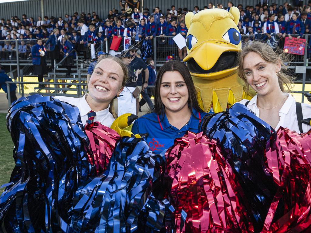 In front of the Downlands supporters stand are (from left) Sarah Holman, Menita Overton and Phoebe Hutchinson with the Downlands Griffin (Patrick McCarthy-Cole). Picture: Kevin Farmer