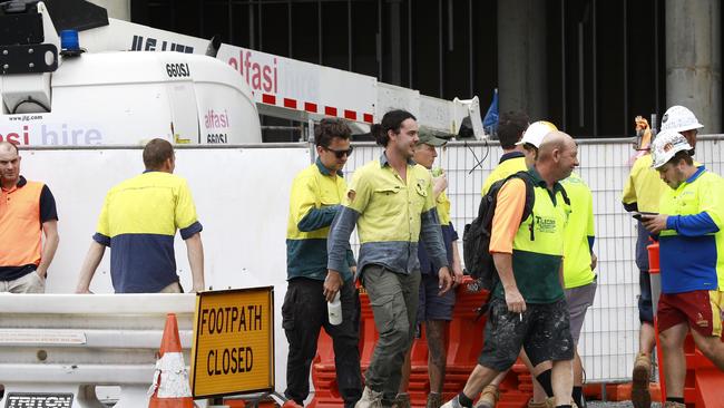 Workers leave the Jewel worksite in Surfers Paradise after three workers were injured on the site. Photo: Tertius Pickard