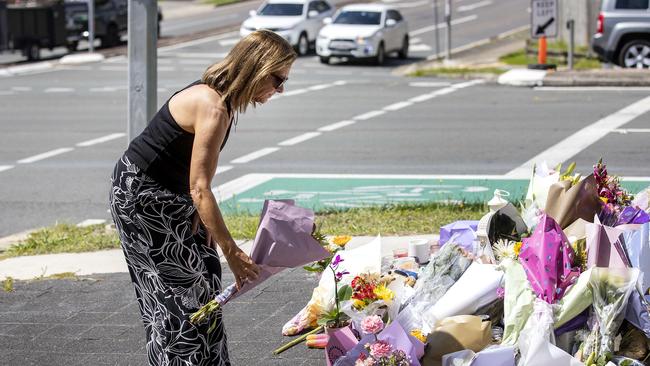 Mourners visit the intersection of Vienna and Finucane Roads in Brisbane’s Alexandra Hills where Kate Leadbetter, 31, and Matthew Field, 37 were fatally struck by a car. Picture: NCA NewsWire / Sarah Marshall