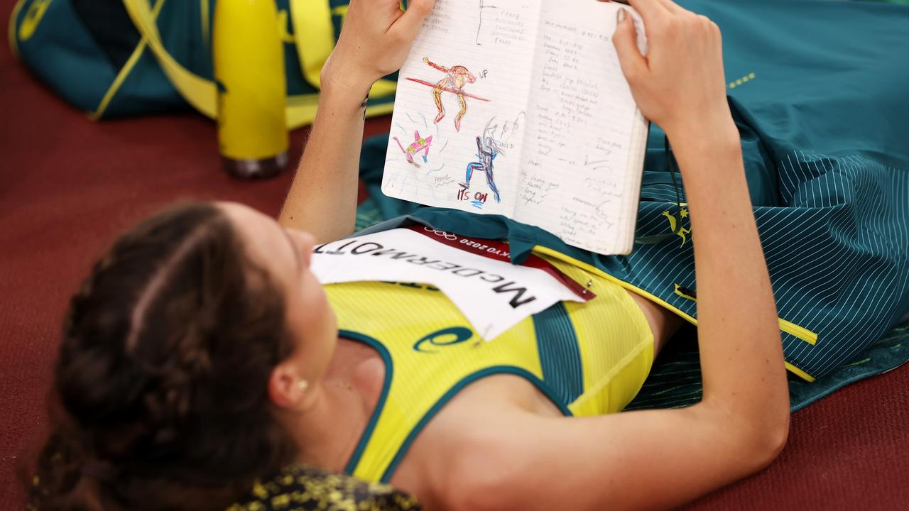 Nicola McDermott of Team Australia reads her journal.