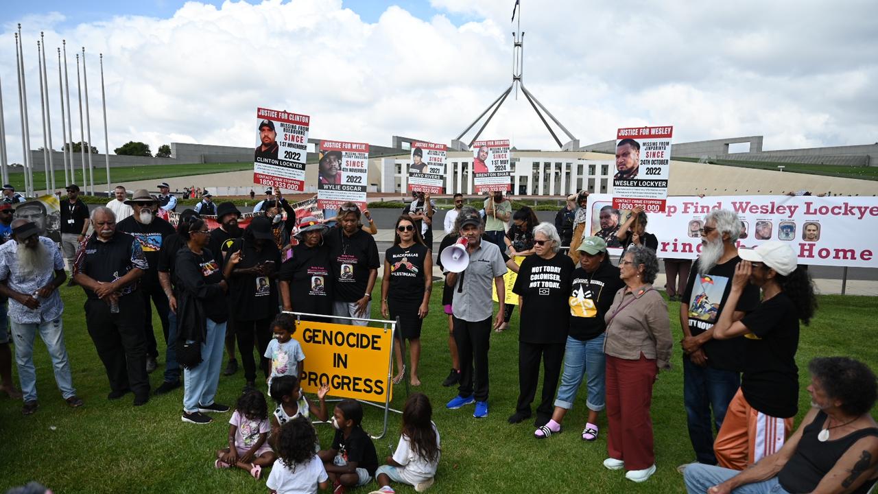 Protesters waved placards accusing the government of committing genocide against Indigenous Australians. Picture: NewsWire/ Martin Ollman