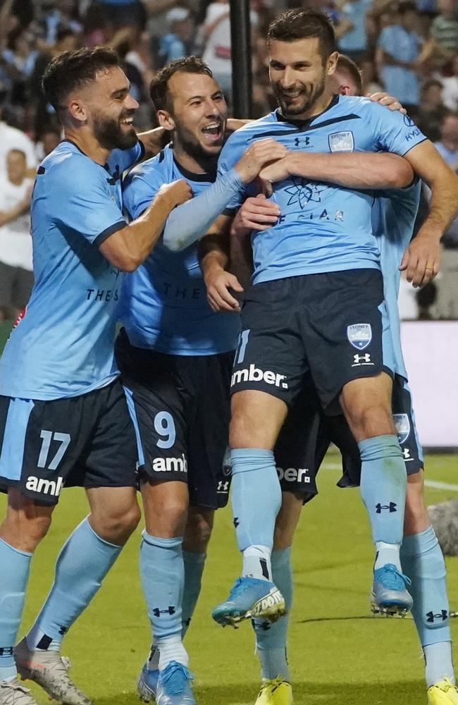 Barbarouses celebrates a winning goal with his Sydney FC teammates.