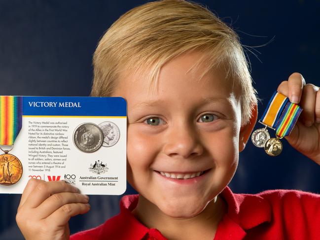 Oscar Pavez (5, from Portarlington Primary School) with the medals collection. He also is holing a miniature Victory medal. Picture Jay Town.