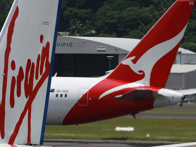 FILE- Virgin Australia and QANTAS tails at Cairns Airport.