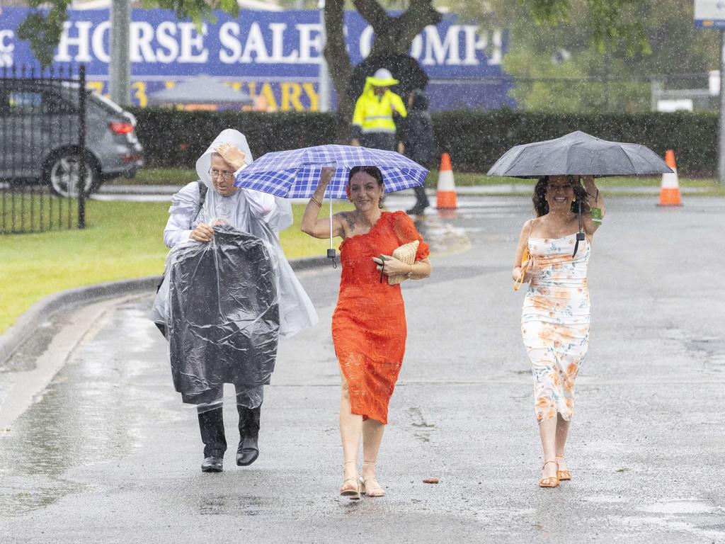 It wasn’t all sunshine though, punters were spotted running through the rain at one point in the day. Picture: Richard Walker