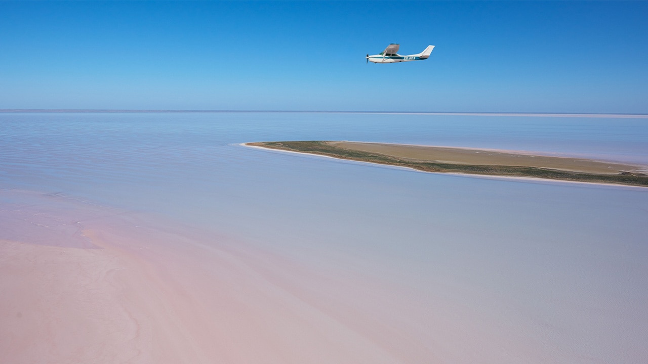 <p>I was on a six-day journey north from Adelaide to William Creek along the Oodnadatta Track with <a href="https://www.outbackspirittours.com.au/" target="_blank" rel="noopener">Outback Spirit</a>, a premium small-group tour company that specialises in accessing our most famous and remote destinations: Arnhem Land, the Kimberley and Pilbara regions, Cape York Peninsula and more.</p><p>Travelling in an immaculate five-star Mercedes-Benz 4WD coach, complete with leather reclining seats, legroom to spare, on-board bathroom and great suspension for comfort on any road, our destination was one of Australia&rsquo;s truly gobsmacking natural events. This vast low-lying basin was now filled via a network of otherwise dry river channels by ex-Tropical Cyclone Kirrily, which had made landfall in Townville before crossing Queensland into the Northern Territory six months earlier.</p>