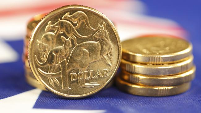 Australian coins sitting on an Australian flag. money coins dollars generic