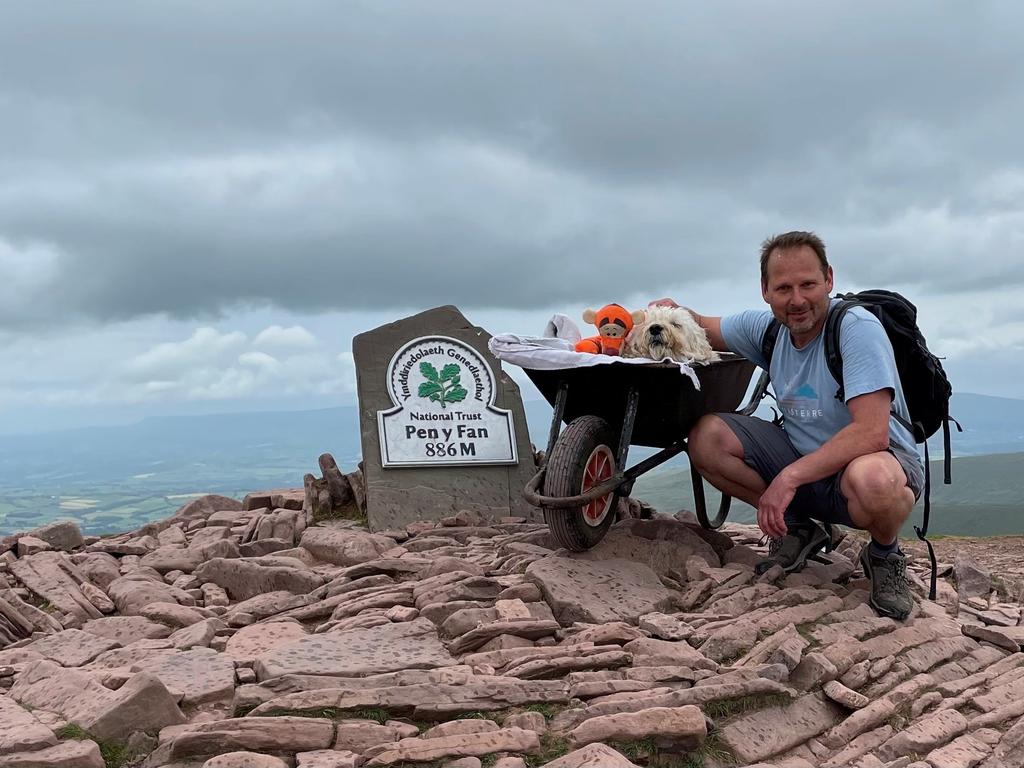 Carlos Fresco took Monty up his favourite mountain, Pen y Fan in the Brecon Beacons, on one last walk – in a wheelbarrow. Picture: SWNS/Mega