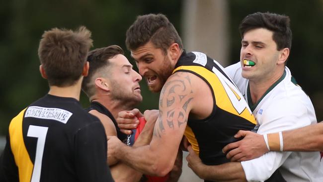 Heidelberg and Northcote Park players jostle for the ball. Picture: Stuart Milligan.