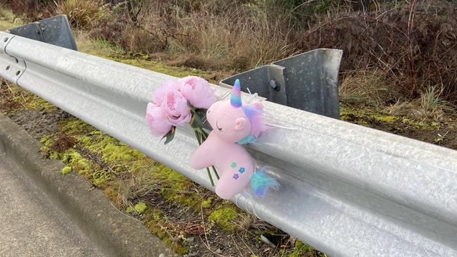 Floral tributes and a small toy unicorn lay at the fatal crash site on Algona Road, where a Huntingfield father and his young daughter were killed in a car crash in 2020. Photo: Phil Young