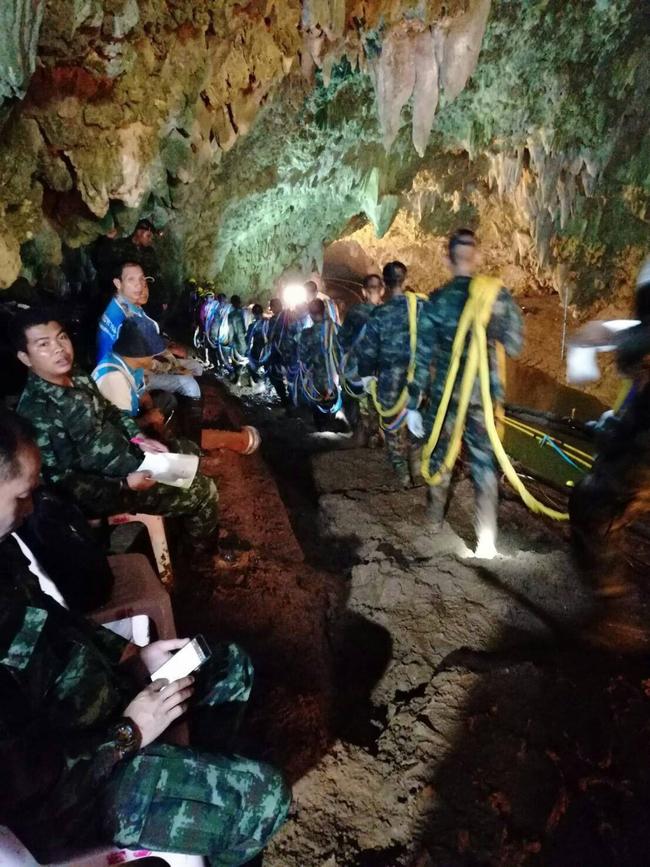 Thai soldiers carrying cables inside Tham Luang cave. Picture: AFP