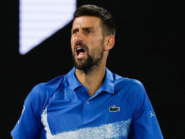 Serbia's Novak Djokovic reacts after a point against Czech Republic's Tomas Machac during their men's singles match on day six of the Australian Open tennis tournament in Melbourne on January 17, 2025. (Photo by Martin KEEP / AFP) / -- IMAGE RESTRICTED TO EDITORIAL USE - STRICTLY NO COMMERCIAL USE --