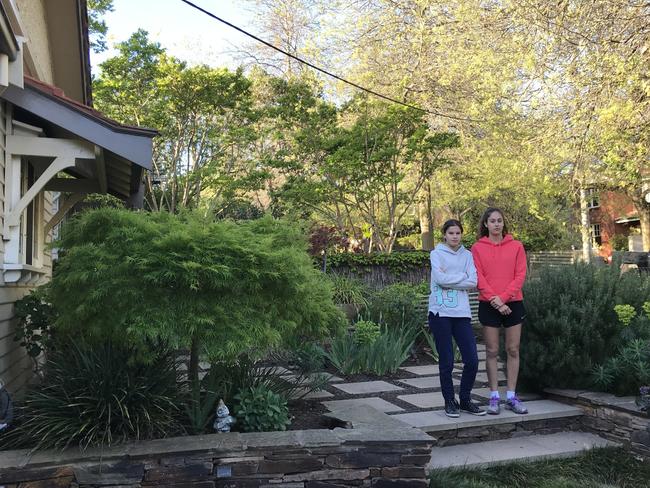 Jemima and Isabella Mellado outside their damaged house.