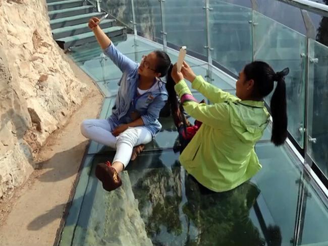 The scenic walkway was just one of many similar transparent tourist attractions that were opened ahead of the seven-day national holidays which started October 1.