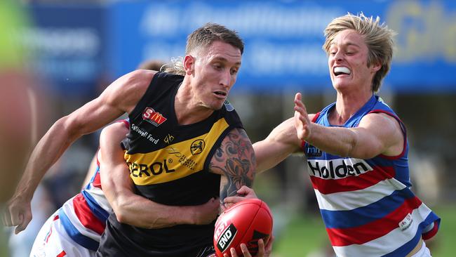 Central's Jackson Hately puts pressure on Glenelg's Jesse White in the SANFL. Picture: Tait Schmaal.