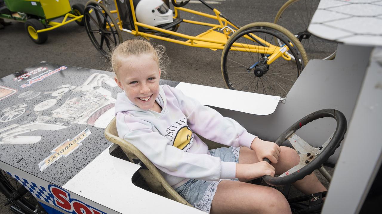 Addison Evans has fun sitting in the Sowerby's Towing cart in the pits at the Greenmount Billy Cart Challenge, Saturday, November 25, 2023. Picture: Kevin Farmer