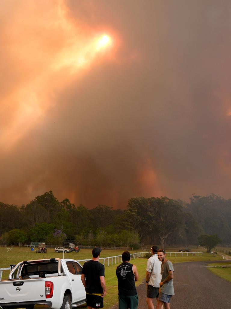 Locals watch as bushfires approach at Nana Glen. Picture: AFP