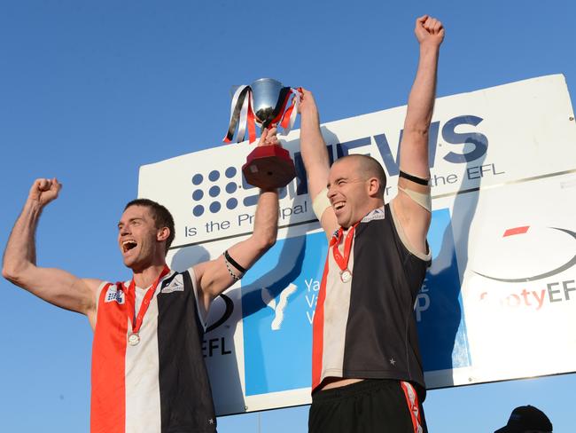 Brett Moyle hoists the Division 3 premiership in 2012.