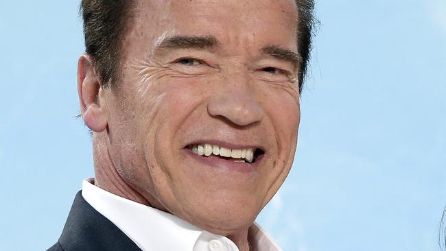 Actor Arnold Schwarzenegger, left, and actress Emilia Clarke joke as they pose for the photographers prior to the Europe premiere of the movie 'Terminator: Genisys' in Berlin, Germany, Sunday, June 21, 2015. (AP Photo/Michael Sohn)