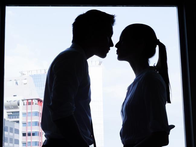 Business couple kissing in the office. Business affair.