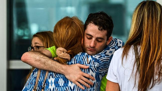 Family members and residents of the Champlain Towers South greet each other outside the Town of Surfside Community Center in Surfside.