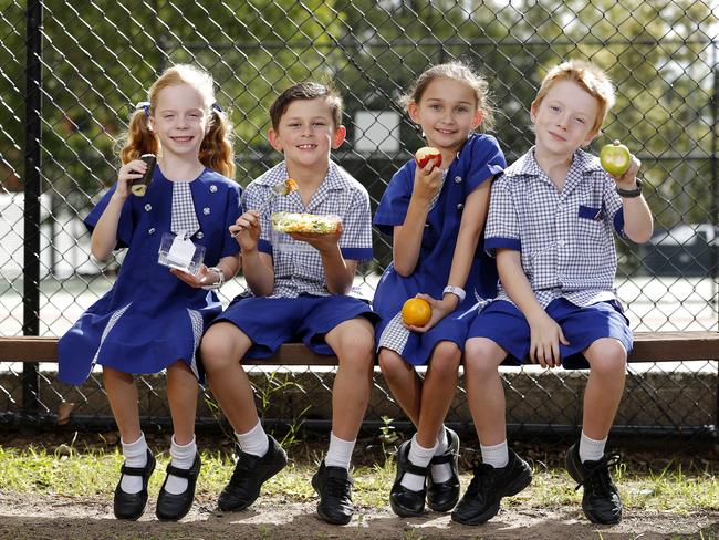 Harper Baer, 6, Fletcher Lee, 7, Ruby Lee, 9 and Oliver Baer, 6, pupils at St Thomas’ in  Camp Hill, Brisbane, enjoy  healthy food options from their tuckshop. 