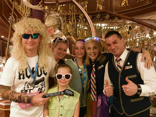 The Chennall family in party mode on board with a crew member. The family say they are keen to cruise again after a tough year. Picture: Supplied