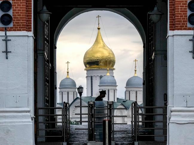 An officer of the Russian Federal security service guards an entrance to the Kremlin. Picture: AFP.