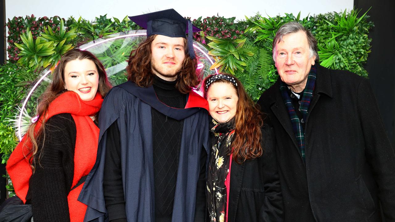 Deakin graduate Vaughan Hill with sister Sophie and parents Kate and Ian. Picture: Alison Wynd