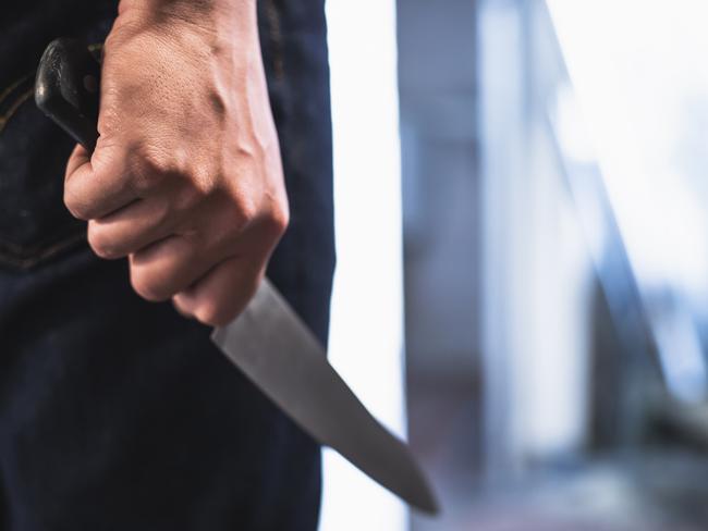 image of a robbers hands holding a knife in the shadows. Picture: iStock