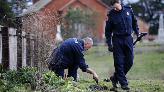 Tasmania Police search for bullet casings in the field adjacent to the residence where Shane Barker was killed. Picture: LUKE BOWDEN