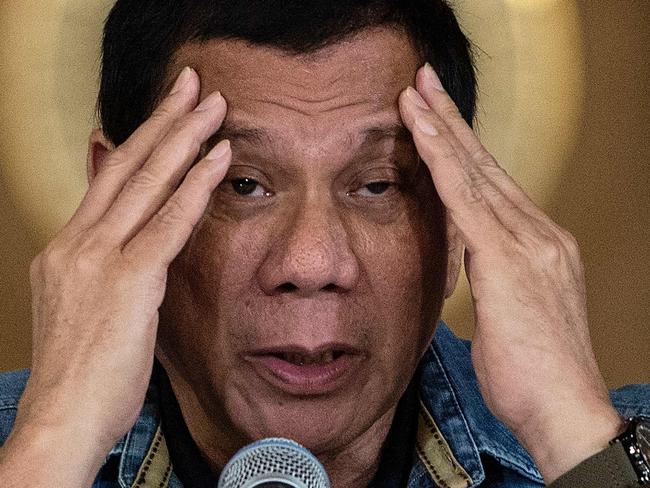 Philippine's President Rodrigo Duterte gestures as he answers a question during a press conference at the Malacanang palace in Manila on January 30, 2017. Philippine's President Rodrigo Duterte on January 30, 2017 extended his deadly drug war until the last day of his term in 2022, but conceded the police force acting as his frontline troops was 