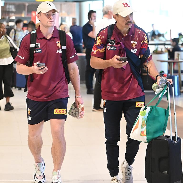 Lachie Neale (left) and Charlie Cameron left Brisbane Airport for Melbourne on Friday – this time, Neale was without a moon boot. Picture: John Gass