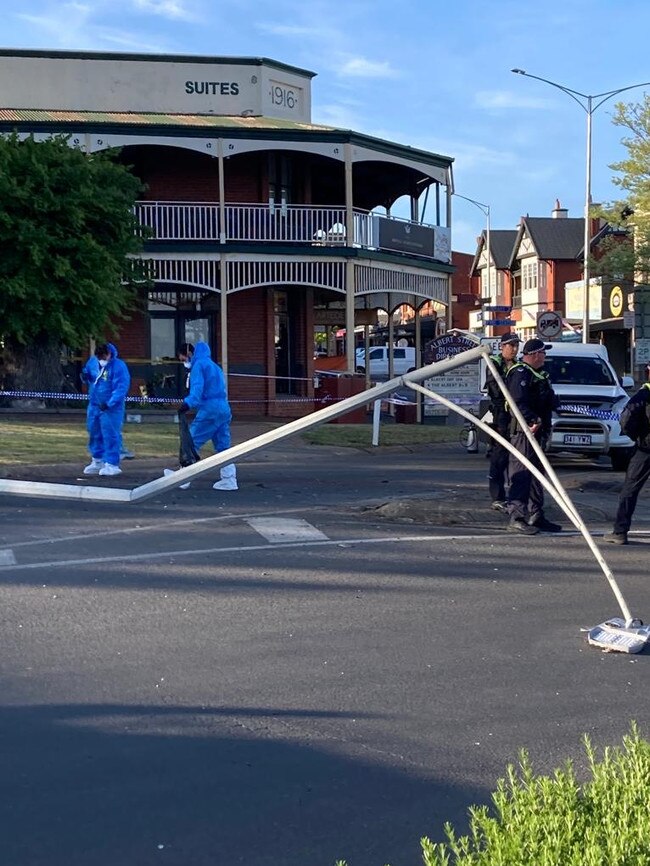 Workers in blue hazmat suits clear the scene at the Daylesford pub the morning after the car crash. Picture: Damon Johnston