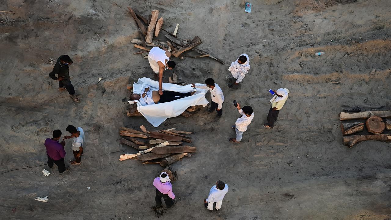 Relatives perform the last rites for the cremation of a man on the banks of the Ganges River after he died of coronavirus. Picture: Ritesh Shukla/Getty Images