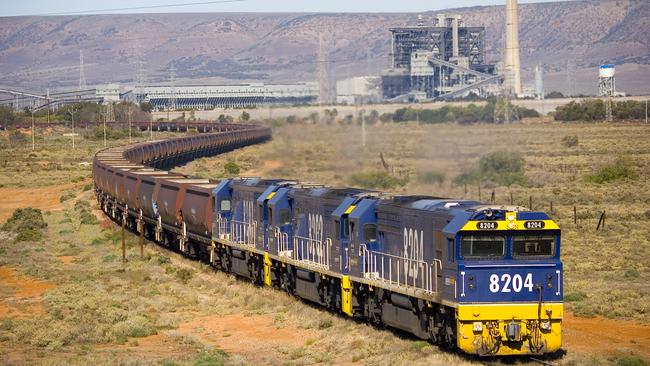 A train hauling coal between Leigh Creek and Port Augusta, with the Northern power station in the background.