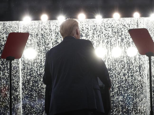 President Donald Trump speaks in the rain behind glass during an Independence Day celebration in front of the Lincoln Memorial, Thursday, July 4, 2019, in Washington. (AP Photo/Carolyn Kaster)