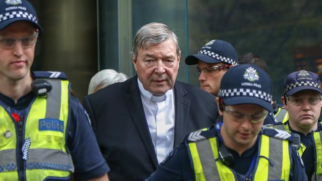 Cardinal George Pell leaves court in Melbourne.