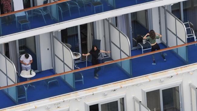 Crew members busy themselves aboard contagious cruise ship Ruby Princess after it was quarantined in April, 2020. Picture: Simon Bullard