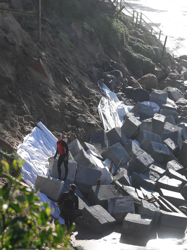 Heavy cement blocks being lowered at the base of Wamberal Beach. Picture: John Grainger