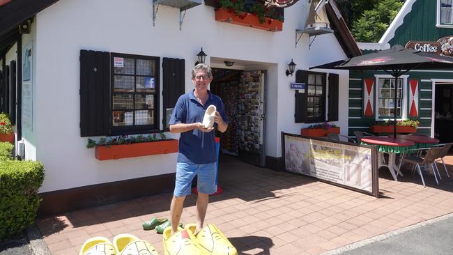 The Clog Barn owner John Hartsuyker stands in the oversized clogs – a popular Instagram moment for tourists. Picture: Chris Knight