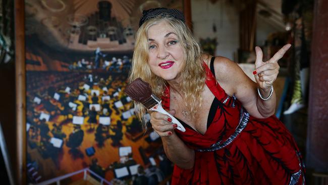 Gretel Pinniger with her portrait of the 1995 Sydney Symphony Orchestra at home in Palm Beach. Photo: Martin Lange