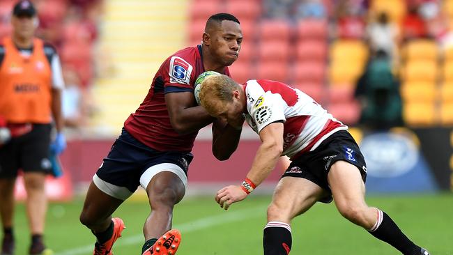 Filipo Daugunu of the Reds takes on the defence of Dillon Smit of the Lions.