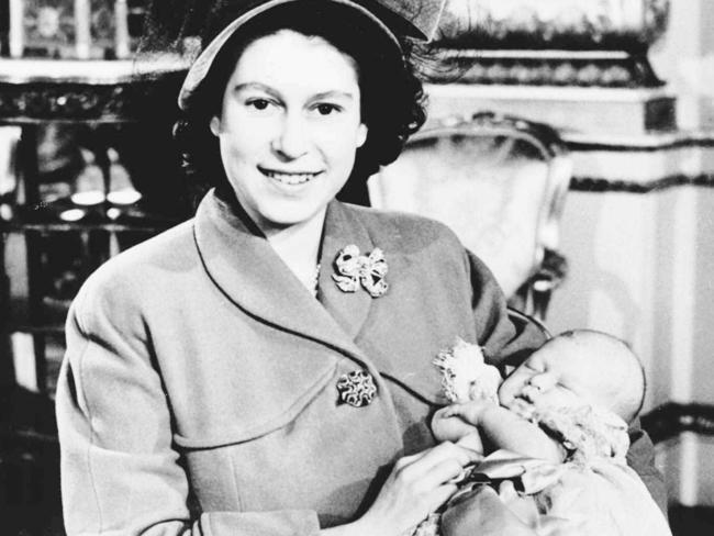 Princess Elizabeth (later Queen Elizabeth II) with a baby Prince Charles at his christening.