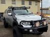 Alleged bikie, two others charged after man kidnapped from shops