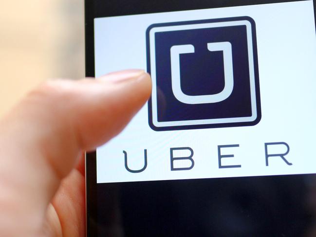 --FILE--A mobile phone user shows the logo of car-hailing app Uber on his smartphone in Chengdu city, southwest China's Sichuan province, 6 May 2015. U.S. firm Uber Technologies Inc and Chinese rival Didi Kuaidi are taking steps to operate legally in China, a key market for both firms but where their car hailing services currently operate in a regulatory prey zone. Uber China said in a statement on Thursday (8 October 2015) it was "actively preparing" documents to apply for a license to operate an online car-hailing platform to meet new regulations governing the sector that are expected to be announced soon. Didi Kuaidi, a $16 billion valued firm backed by Chinese Internet giants Alibaba Group Holding Ltd and Tencent Holdings Ltd, also said on Thursday it had received a car booking license for its operations in Shanghai and that it was seeking more licenses from other cities.