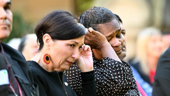 Queensland MP Leeanne Enoch (centre) and the Member for Cook Cynthia Lui (right) are overcome with emotions during the signing the Statement of Commitment to the Path to Treaty.