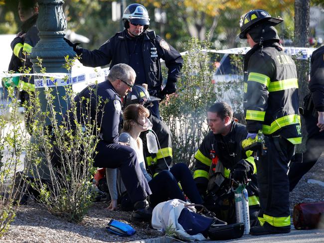 A woman is aided by first responders after sustaining injury on a bike path in lower Manhattan. Picture: Reuters