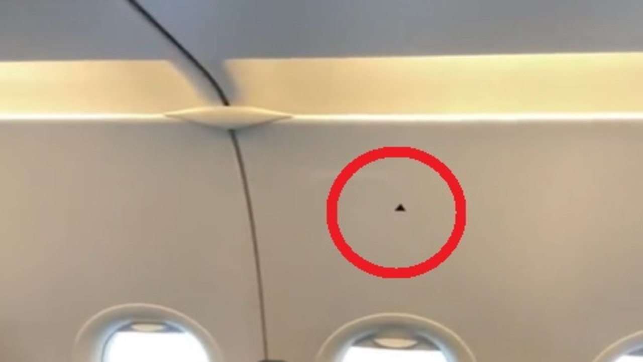 A flight attendant has revealed the ‘secret’ meaning behind the tiny black triangle stickers often found on cabin walls. Picture: TikTok/_hennylim